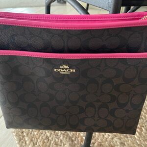 COACH signature messenger crossbody bag zippered with hot pink trim.